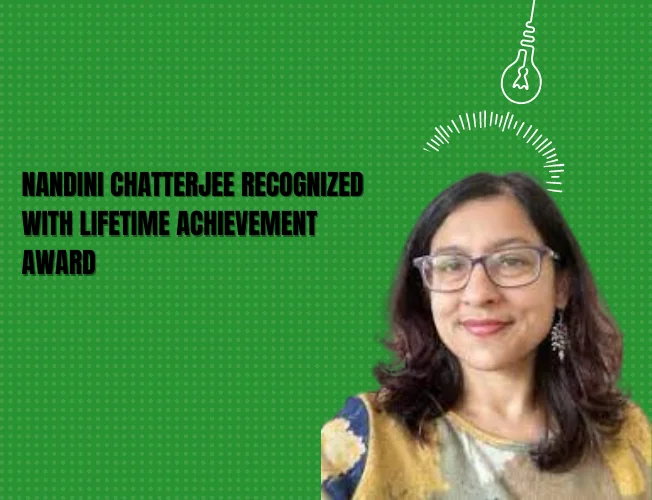 Nandini Chatterjee receiving the Lifetime Achievement Award at Women Achievers' Awards 2023, standing on stage with a trophy in hand.