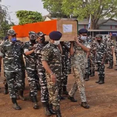 A somber image depicting security personnel in Bastar, Chhattisgarh, amid the aftermath of a tragic clash with Maoists. The image reflects the challenges faced in conflict-prone regions.