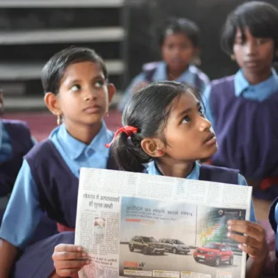 A group of diverse students studying together in a rural school setting.