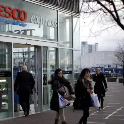 Tesco storefront adorned with Christmas decorations, showcasing a bustling and festive atmosphere during the holiday season.