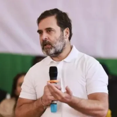 Rahul Gandhi surrounded by security personnel and party workers during chaotic political event in Assam.