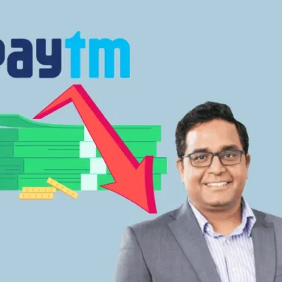 Paytm logo on a smartphone screen displaying financial impact projections.
