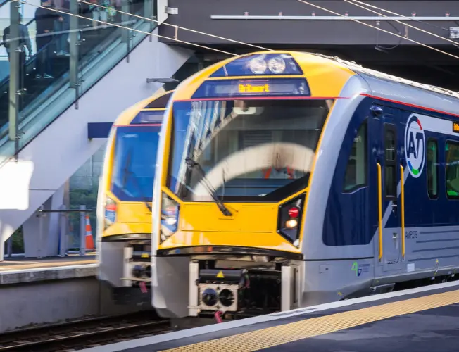 Melted train track with high temperature reading, representing Auckland train disruptions due to extreme heat.