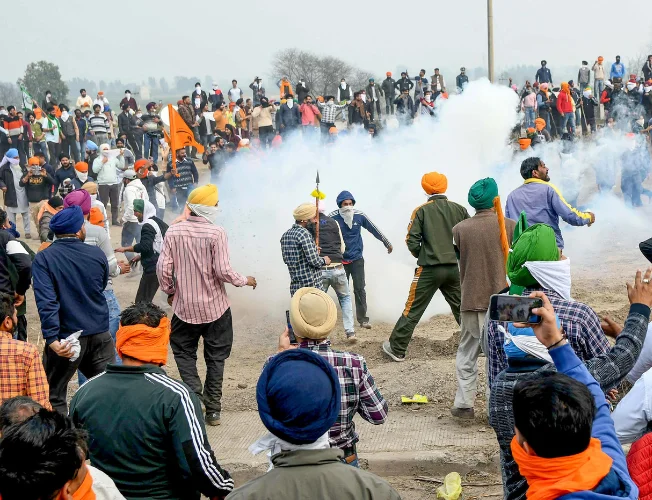 Farmers' protest in India, confrontation at Delhi border, tear gas smoke.