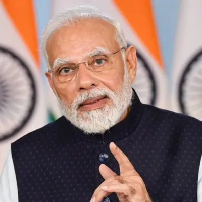 Prime Minister Narendra Modi speaks in Jammu and Kashmir, development projects visible.