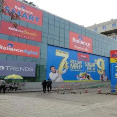 Split image: Tata retail store (Starbucks), Reliance retail store (Reliance Trends) in Mumbai.