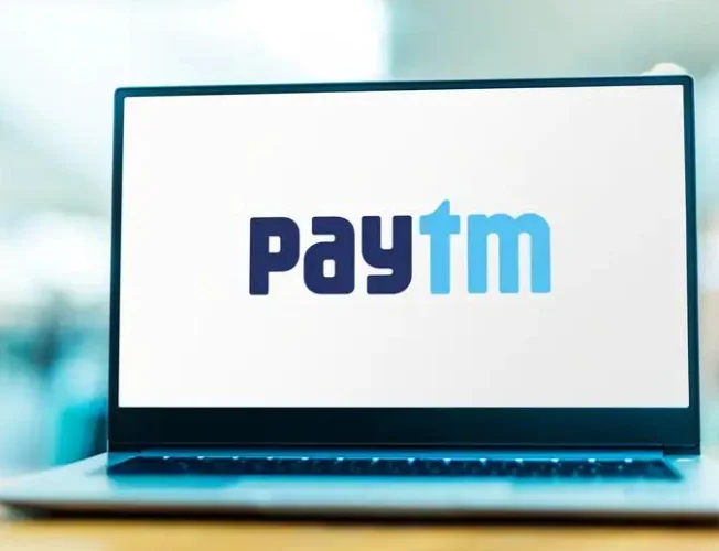 Gavel on document with logos of Paytm, ED, and RBI.