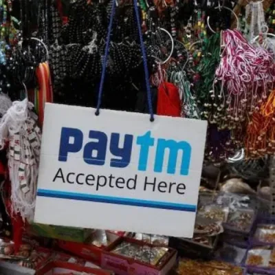 A line graph showing a downward trend, symbolizing the decline in Paytm's stock price. Regulatory restrictions and leadership changes are depicted as icons beside the graph