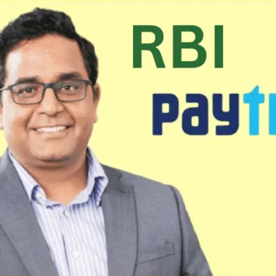 Illustration depicting the RBI logo and a magnifying glass, symbolizing regulatory scrutiny on Paytm.