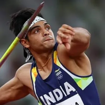 Neeraj Chopra holding a javelin with the Visa logo in the background.