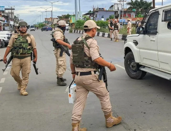 Manipur police personnel patrolling the streets.