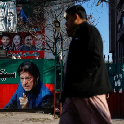 Election results being displayed on a screen with political party symbols.