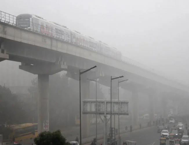 People navigating through wet streets during unexpected rain in Delhi-NCR.