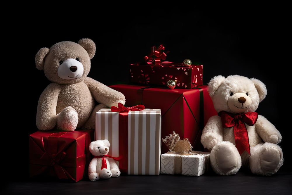 Happy couple holding teddy bears while smiling at each other.