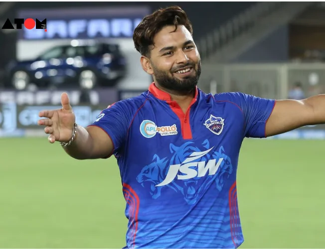 Rishabh Pant, wearing the Delhi Capitals uniform, strides confidently onto the cricket field, symbolizing his triumphant return to the sport after overcoming a challenging injury setback.