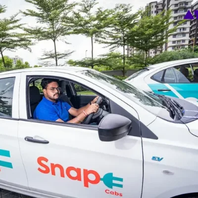 Snap-E Cabs electric vehicles driving through Kolkata streets.