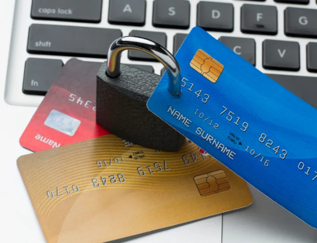 A person holding a credit card, surrounded by caution signs, symbolizing financial pitfalls.