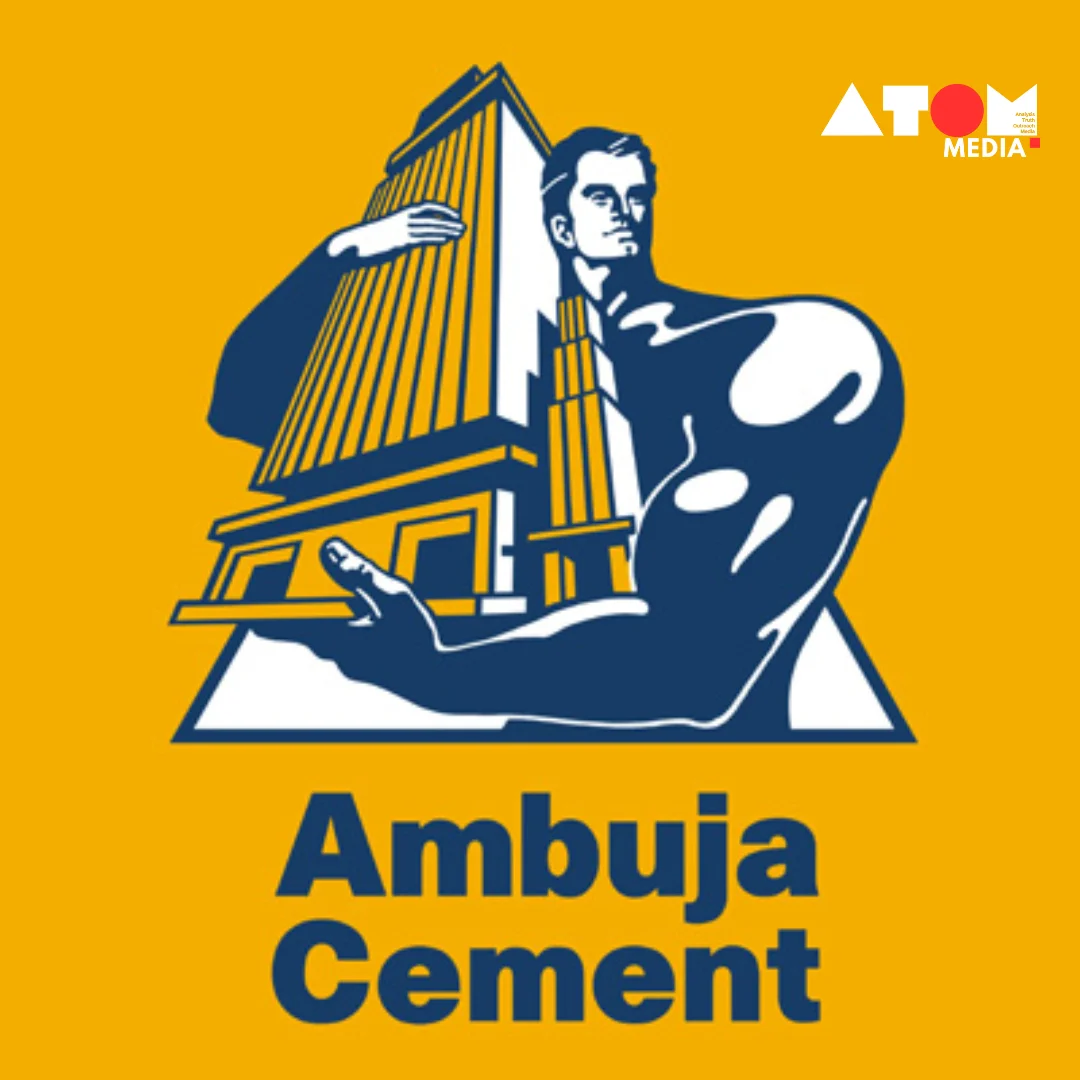 Image depicts a large Ambuja Cement factory building located near a port with cargo ships visible in the background. The acquisition of My Home Group's grinding unit expands Ambuja Cements' capacity and reach in the South Indian market.