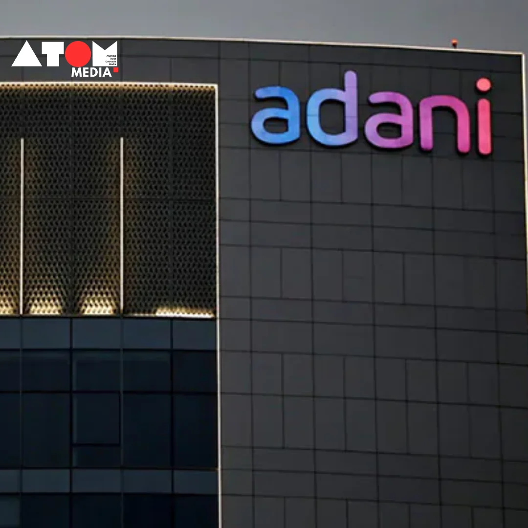 : Image shows the Adani Group logo with text indicating the release of Rs 26,500 crore pledged shares in FY24.