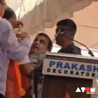 The image captures Union Minister Nitin Gadkari delivering a speech at an election rally in Maharashtra amidst a crowd of supporters.