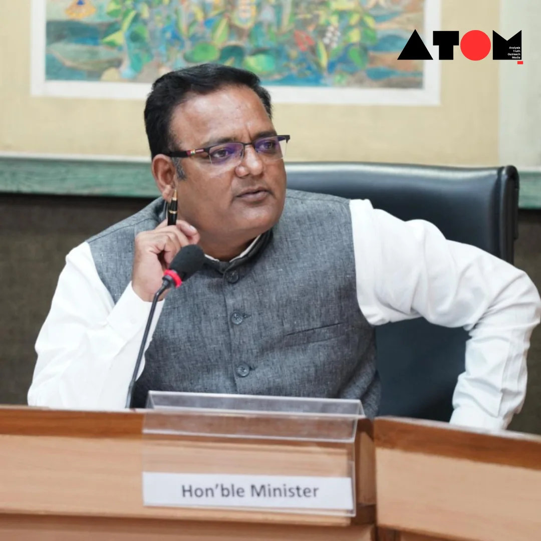 The image captures Delhi Minister Raaj Kumar Anand making a public announcement regarding his resignation from the Aam Aadmi Party (AAP) due to allegations of corruption within the party. Anand stands behind a podium, addressing a crowd of reporters and party members.