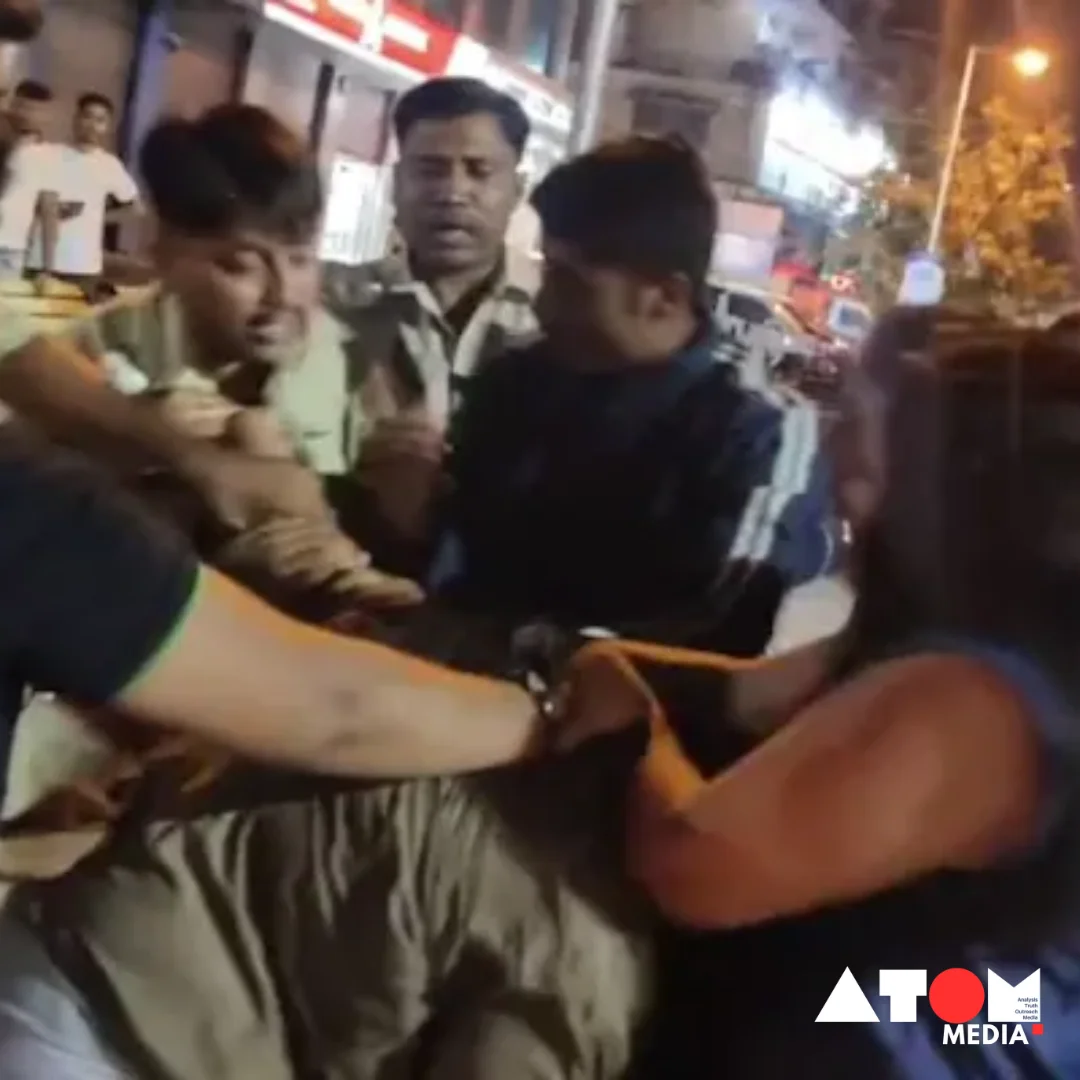 The image shows three women involved in a confrontation with police officers outside a bar in Maharashtra. The women appear agitated, while police officers attempt to restrain them.