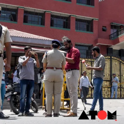 : A photo showing a school building with students and staff evacuating due to bomb threats in Jaipur.