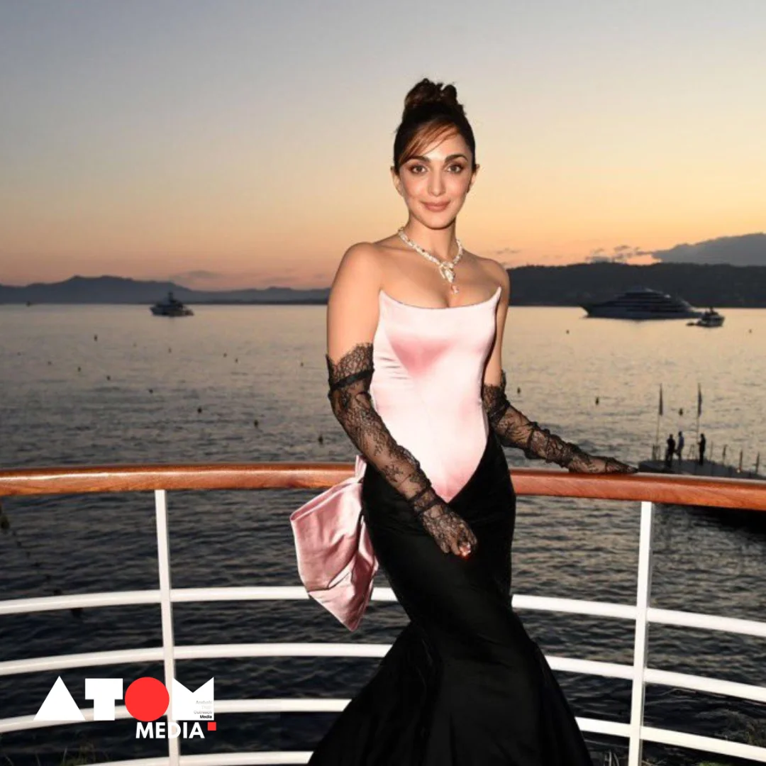 Kiara Advani exudes glamour and sophistication as she graces the Cannes red carpet in a mesmerizing pink and black ensemble, complete with a statement bow detail.