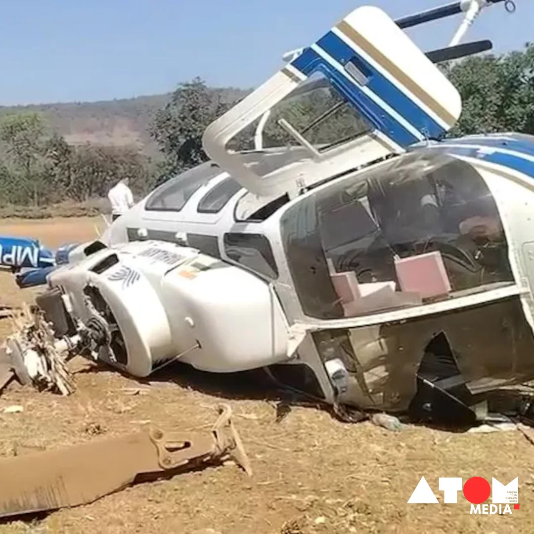 The image depicts the aftermath of a helicopter crash in Maharashtra, where emergency responders are seen assessing the situation and providing assistance. The crash occurred during an attempt to pick up Shiv Sena Deputy Leader Sushma Andhare, highlighting the potential risks associated with aerial transportation.