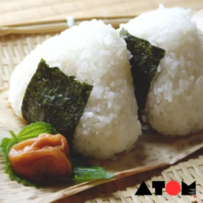 This image captures a chef utilizing their armpits to shape rice balls, a part of Japan's unconventional culinary trend. The process, aimed at infusing armpit sweat into the rice balls, has sparked global fascination and debate. Despite hygiene concerns, the trend reflects a blend of cultural significance and innovative culinary experimentation.