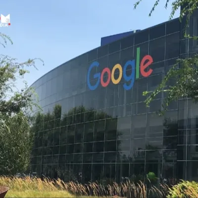 A modern office building with the Google logo displayed prominently. In the background, a map of India highlights Bengaluru.