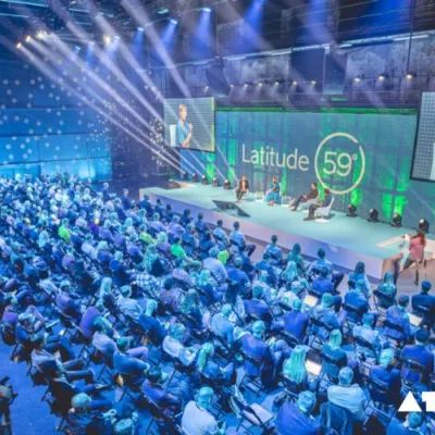 The image depicts Indian entrepreneurs networking and exchanging ideas at Latitude59, Estonia's premier tech event, showcasing collaboration opportunities in the global startup ecosystem.