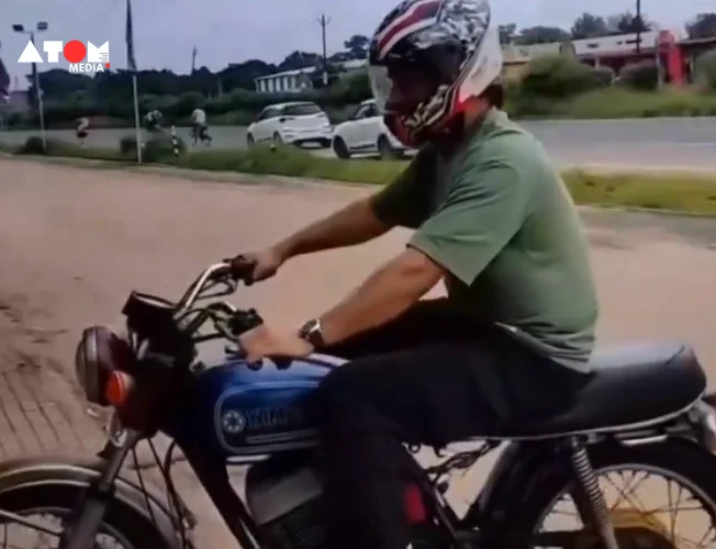 MS Dhoni riding a bike on Ranchi streets wearing a helmet and green T-shirt