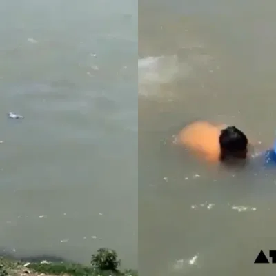 Locals rescuing a 7-year-old boy from drowning in the Jhelum River in Srinagar