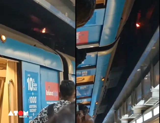 A Delhi Metro train with a pantograph extended towards the overhead electrical wires.