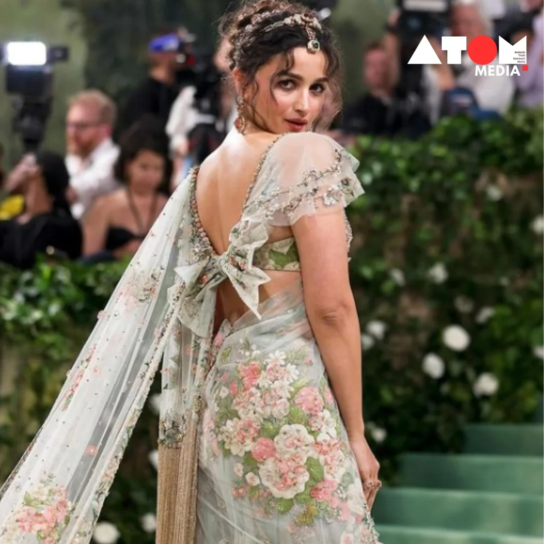 Alia Bhatt captivates onlookers at Met Gala 2024 wearing a custom-made Sabyasachi saree embellished with luxurious sapphires and emeralds. Her regal ensemble exudes elegance and sophistication, showcasing India's rich cultural heritage on the international stage.