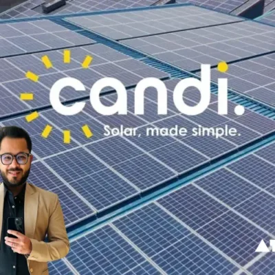 A large-scale solar power plant with rows of photovoltaic panels gleaming in the sunlight.