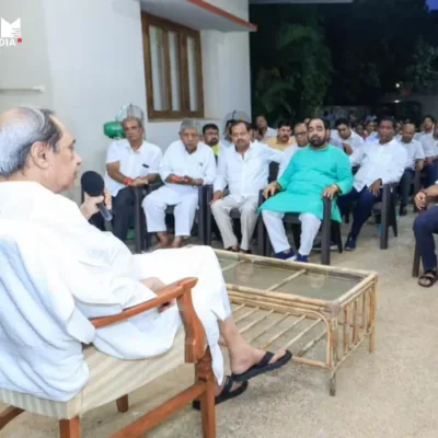 BJD leaders discussing strategy in a political meeting.