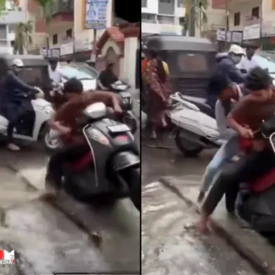 Image showing waterlogged potholes on a street in Pune's Dighi area, causing difficulties for commuters.