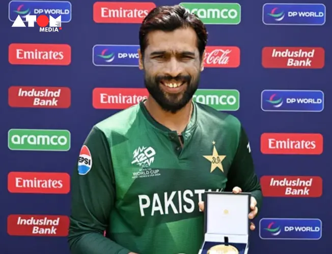 Pakistan's Mohammad Amir walks near the boundary during a T20 World Cup match as a fan yells in the background.