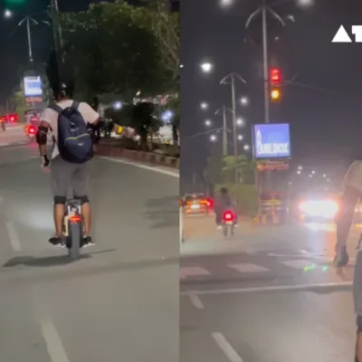 Unicyclist navigates busy Indian street.